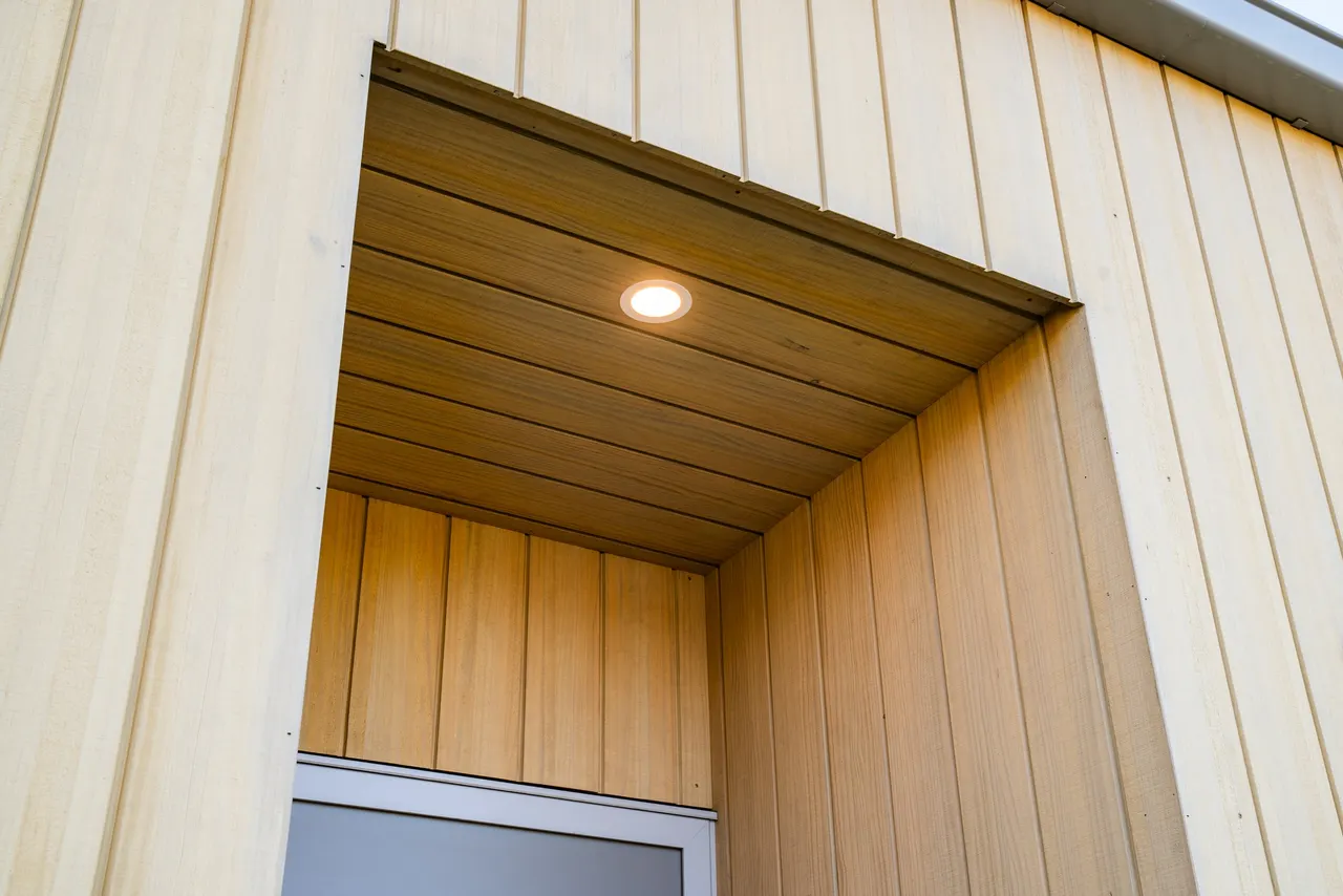 Entry foyer with custom vertical timber wall panelling