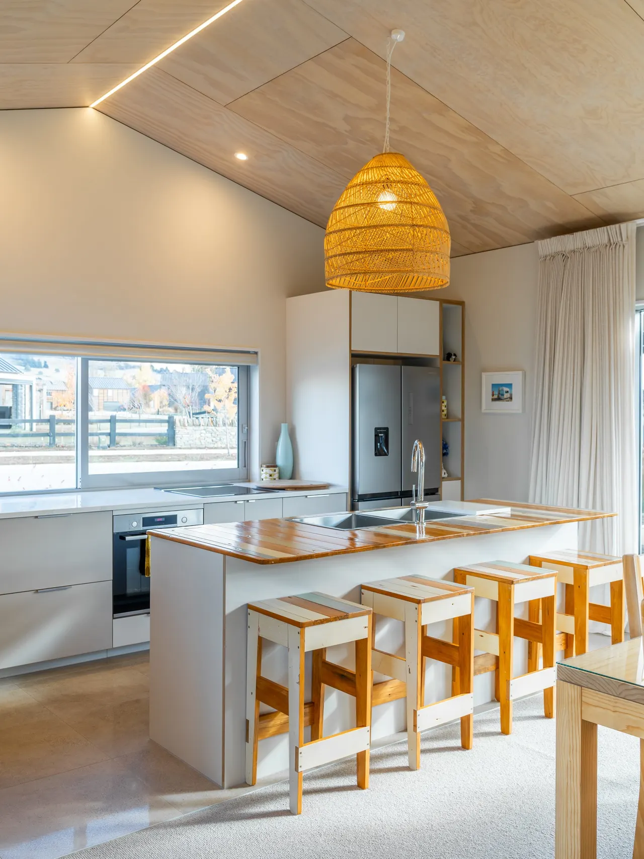 Kitchen island with stone benchtop and custom cabinetry