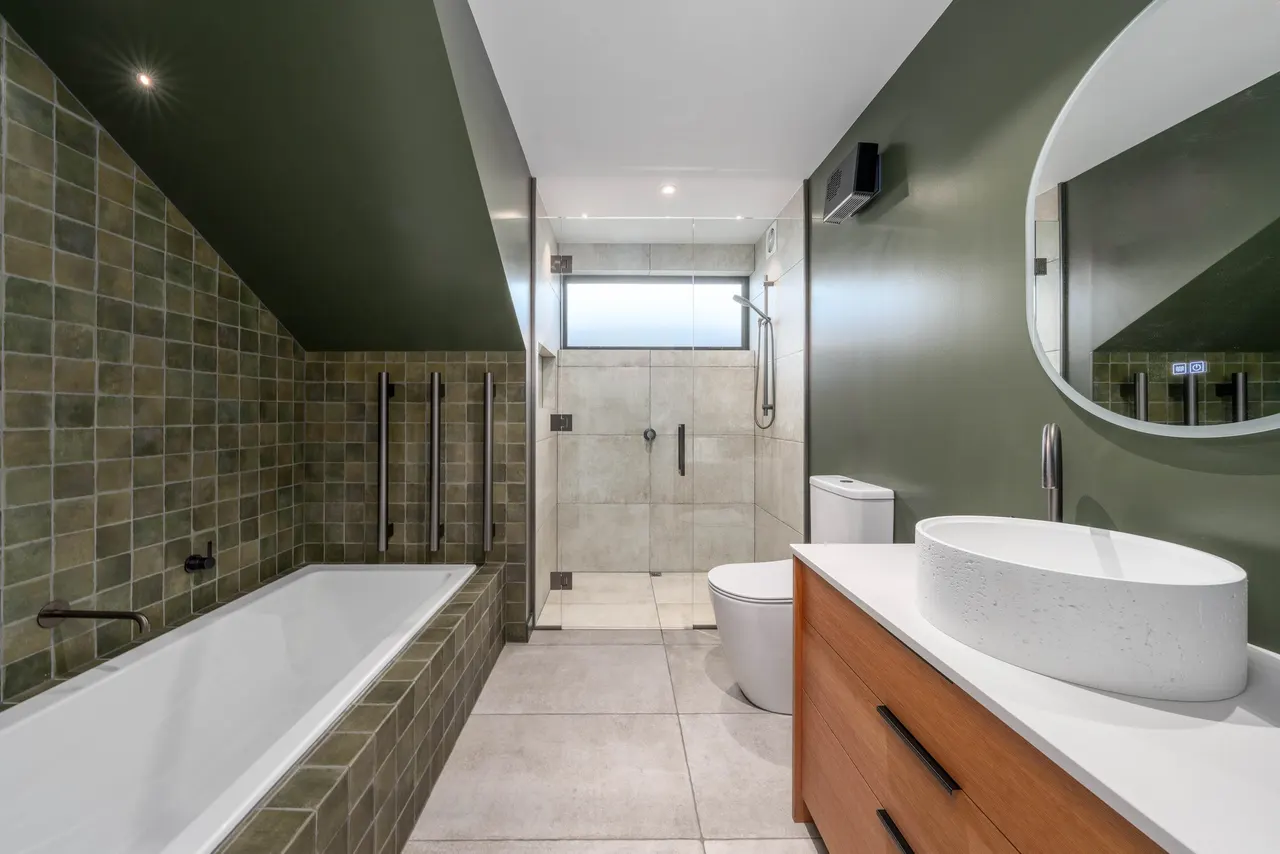 Family bathroom with feature ceramic tile bath