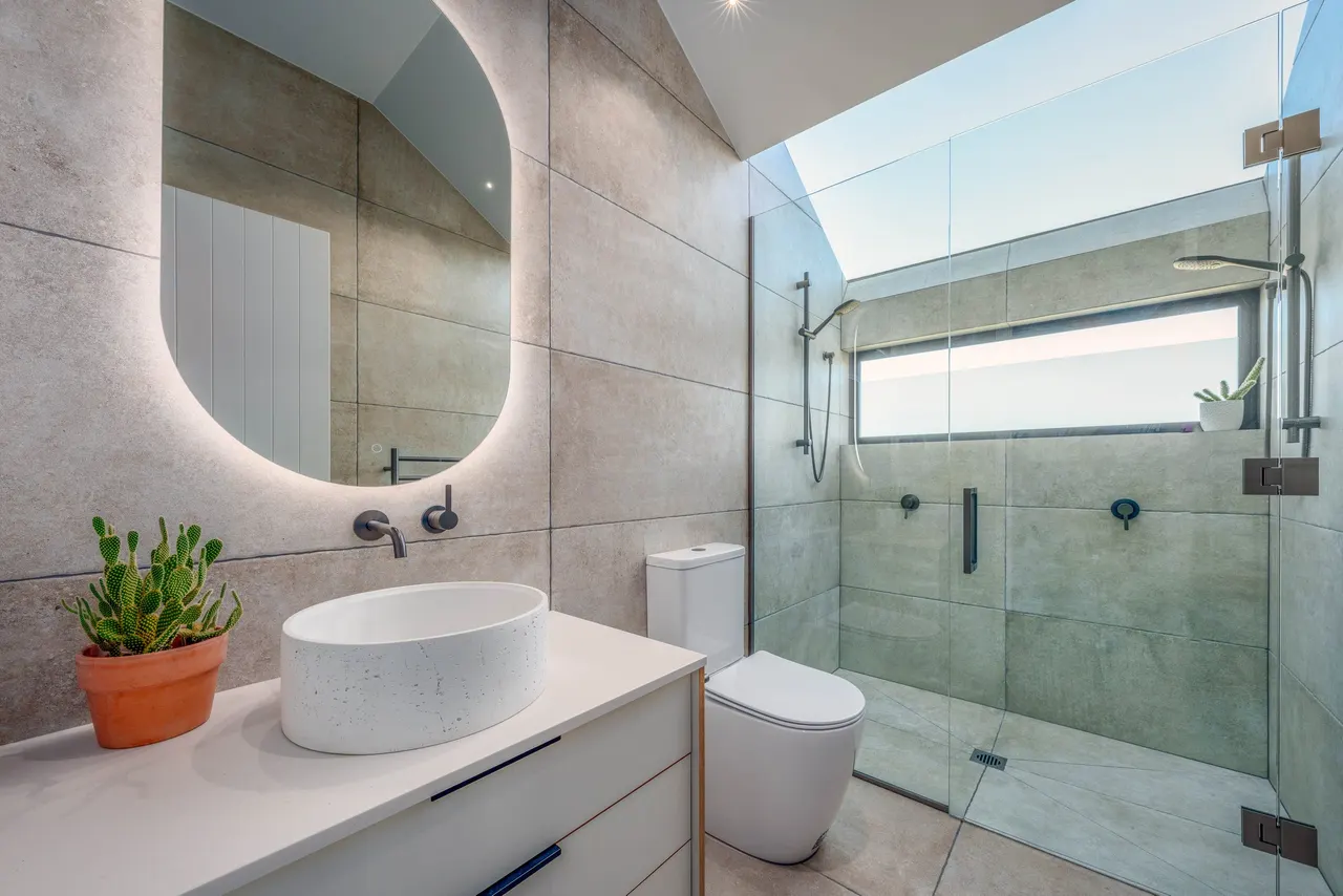 Master ensuite with an overhead skylight above the tiled shower