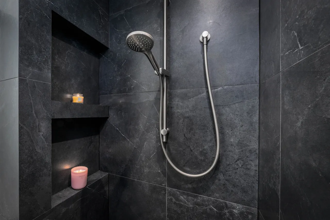 Artisan wall tiling with brushed tapware